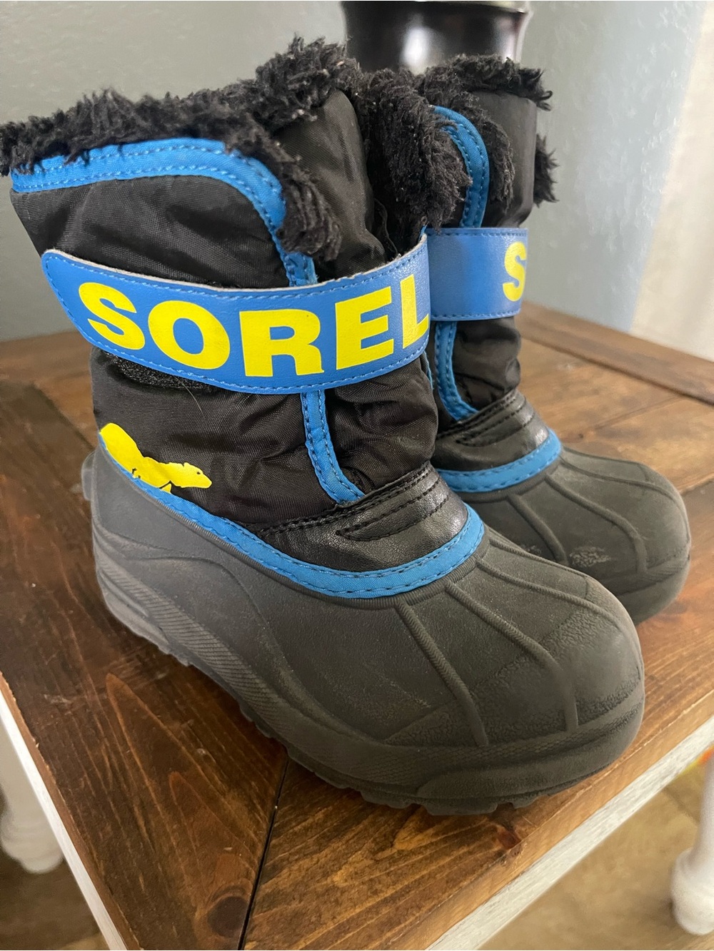 Sorel Kids' Black Boots with Blue Accents and Yellow Logo